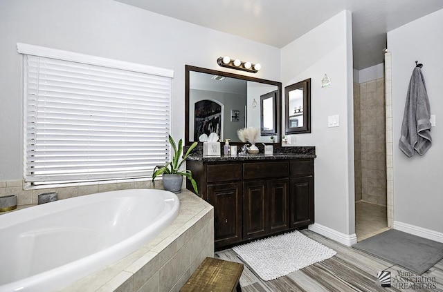 bathroom featuring vanity and plus walk in shower