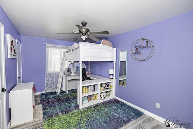 bedroom with wood-type flooring and ceiling fan