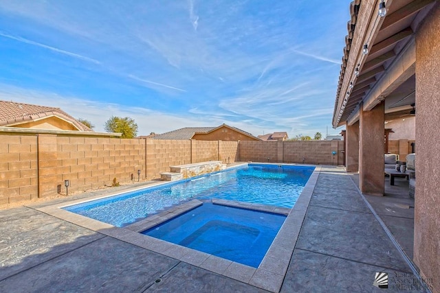 view of pool with an in ground hot tub