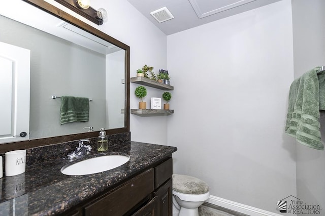 bathroom featuring vanity and toilet