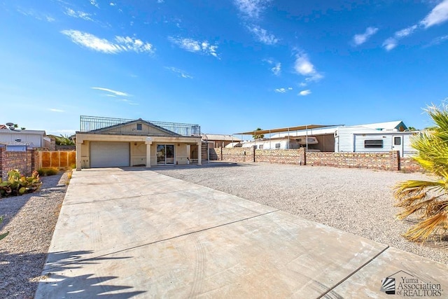 view of front of home with a carport and a garage