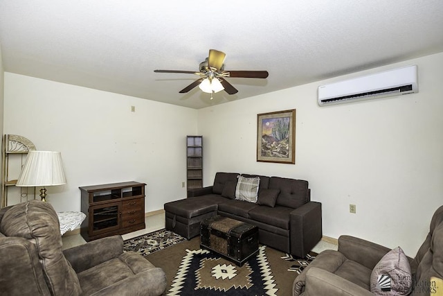 living room with a wall unit AC and ceiling fan