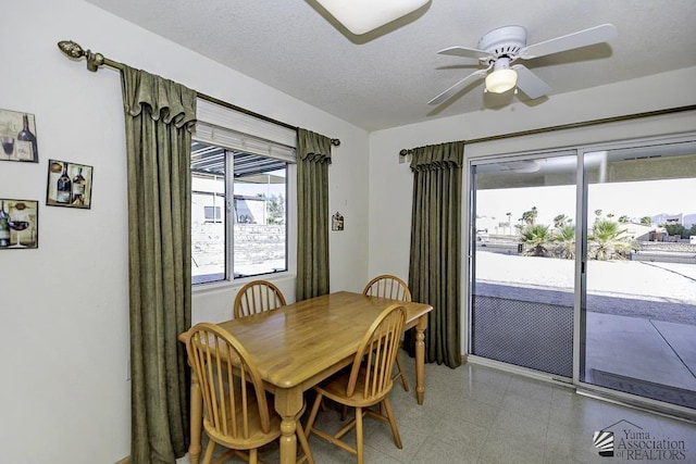 dining area featuring a textured ceiling and ceiling fan