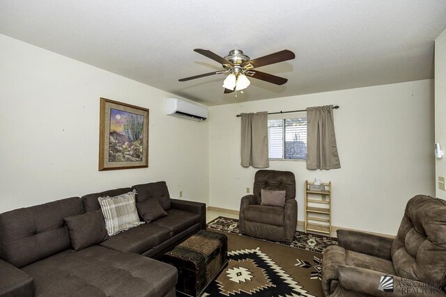 living room featuring ceiling fan and a wall mounted AC