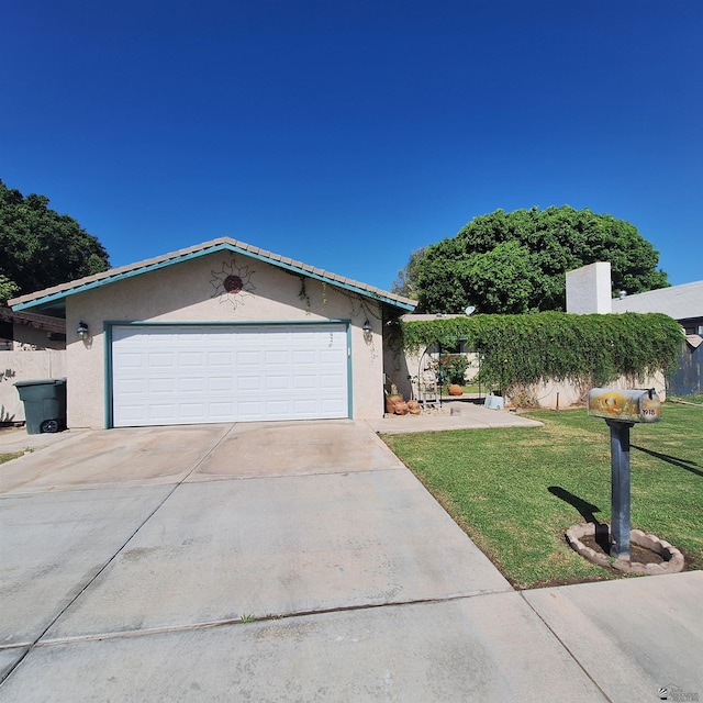 view of front of property featuring a garage and a front lawn