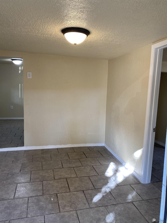 spare room featuring a textured ceiling