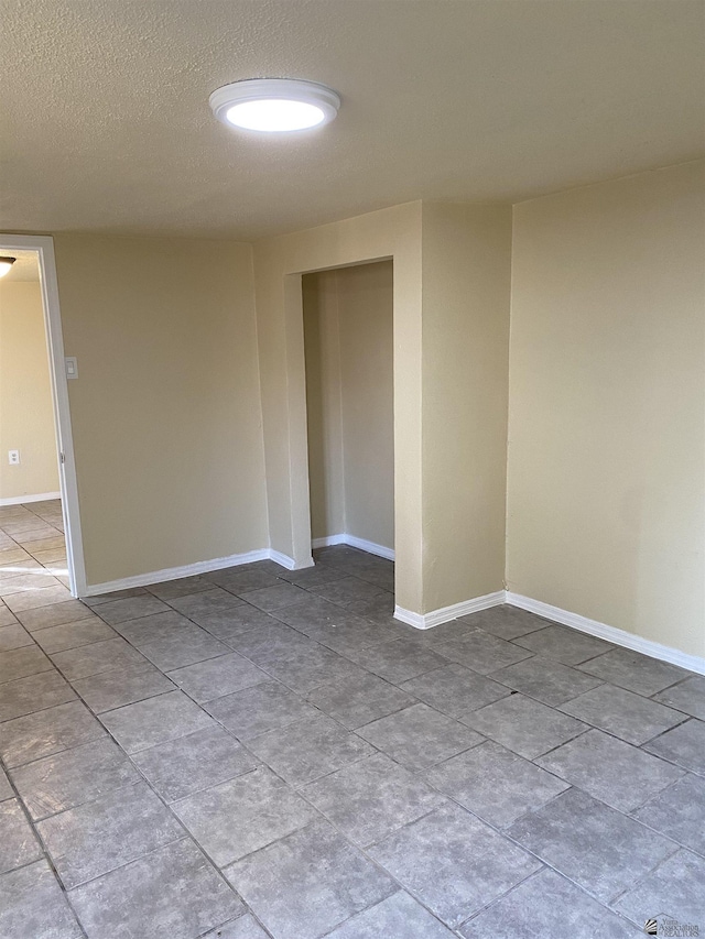 unfurnished room featuring a textured ceiling