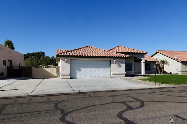 mediterranean / spanish home featuring a garage