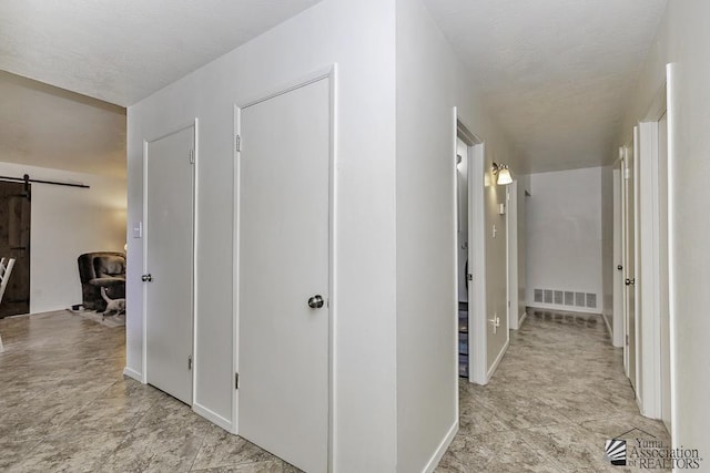 hallway featuring a barn door