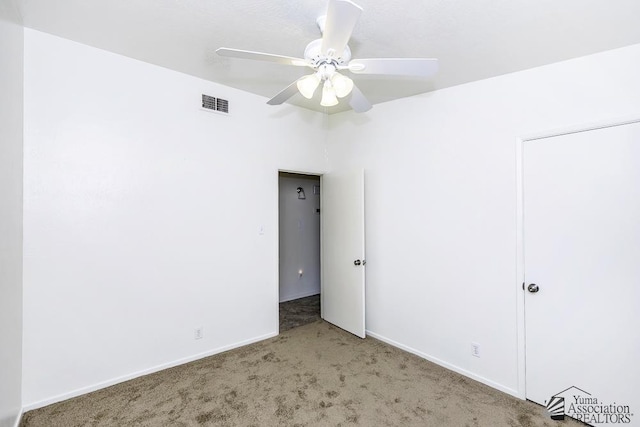 empty room with ceiling fan and carpet flooring