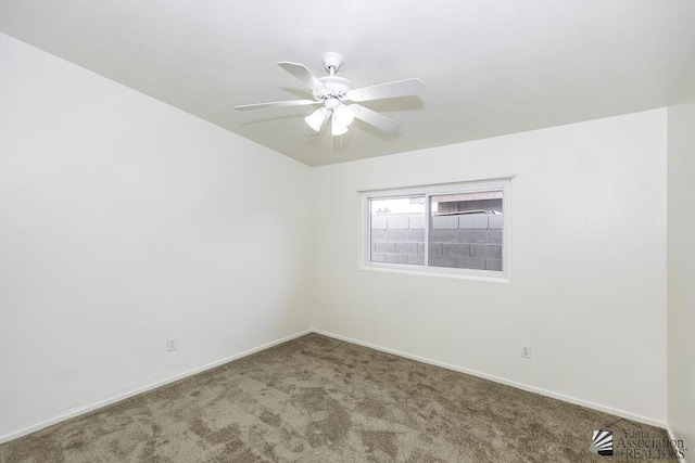 spare room featuring ceiling fan and carpet