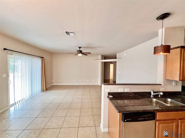 kitchen with ceiling fan, sink, hanging light fixtures, stainless steel dishwasher, and light tile patterned floors