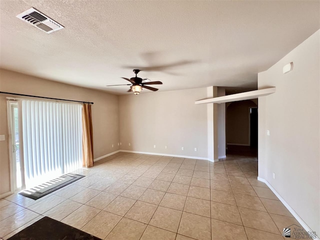 spare room featuring light tile patterned floors and ceiling fan