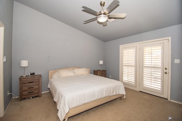 bedroom featuring light carpet, access to outside, vaulted ceiling, and a ceiling fan