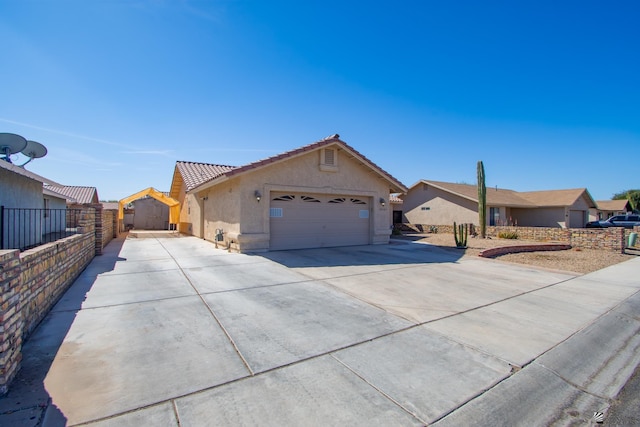 ranch-style home with driveway, a garage, a tiled roof, fence, and stucco siding