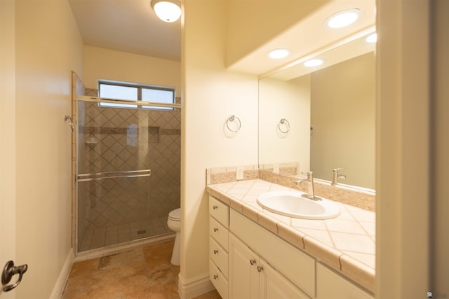 bathroom with an enclosed shower, vanity, and toilet