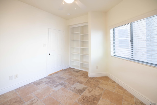 spare room featuring ceiling fan and built in features