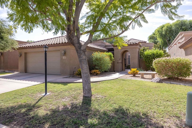 mediterranean / spanish house with a garage and a front yard