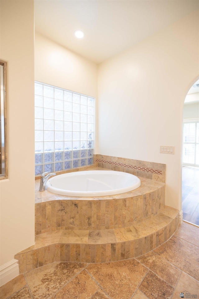 bathroom with tiled tub