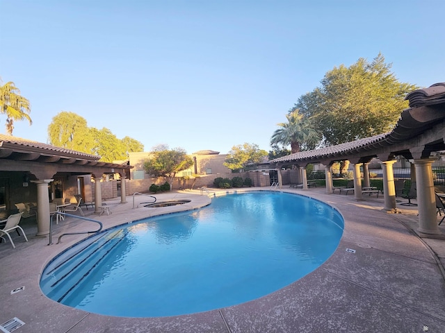 view of swimming pool with a patio area and an in ground hot tub