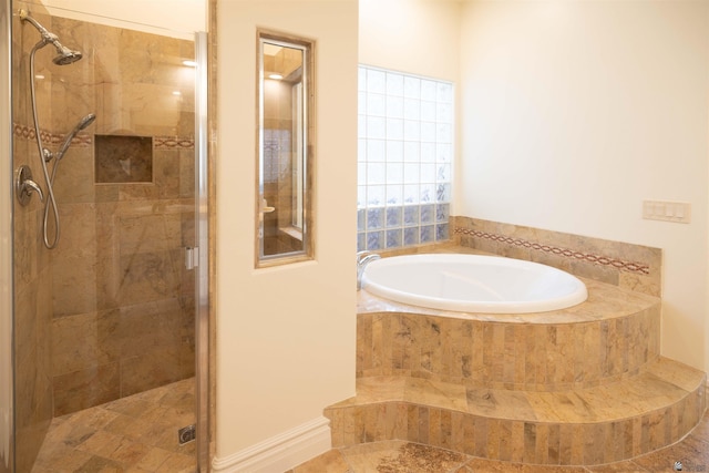 bathroom featuring independent shower and bath