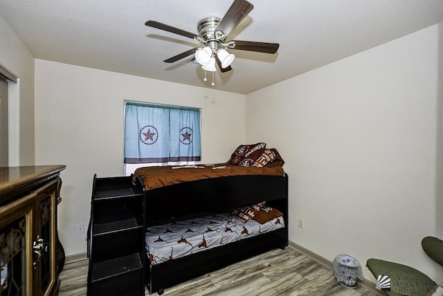 bedroom featuring hardwood / wood-style floors and ceiling fan