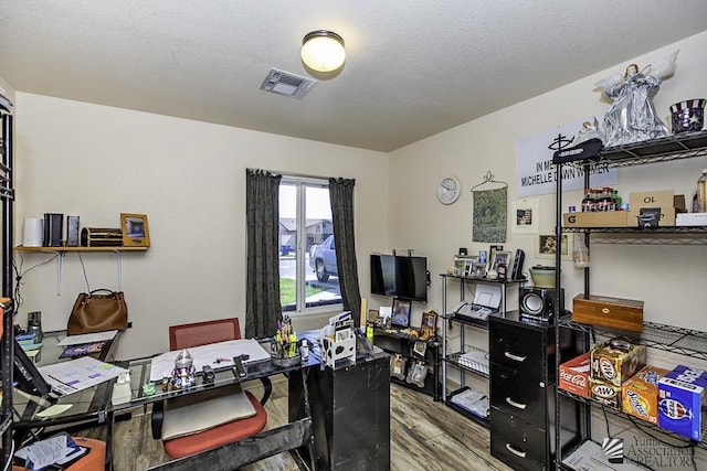 office space with hardwood / wood-style floors and a textured ceiling