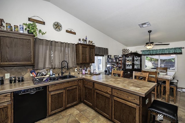 kitchen with dishwasher, vaulted ceiling, ceiling fan, tasteful backsplash, and kitchen peninsula