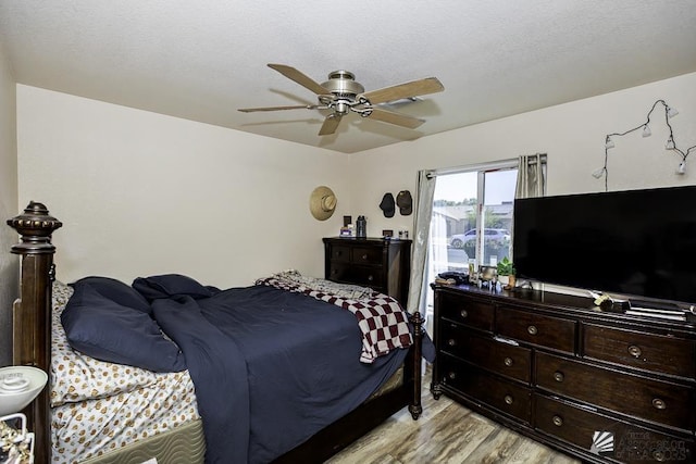 bedroom with ceiling fan and light wood-type flooring