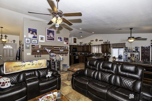 tiled living room with ceiling fan with notable chandelier, a textured ceiling, and vaulted ceiling