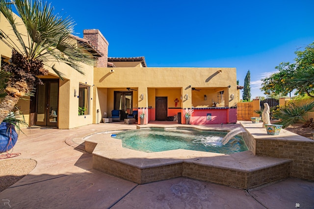 view of pool with french doors, a patio, pool water feature, and ceiling fan