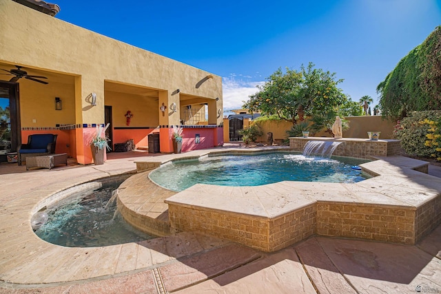 view of swimming pool featuring pool water feature and a patio