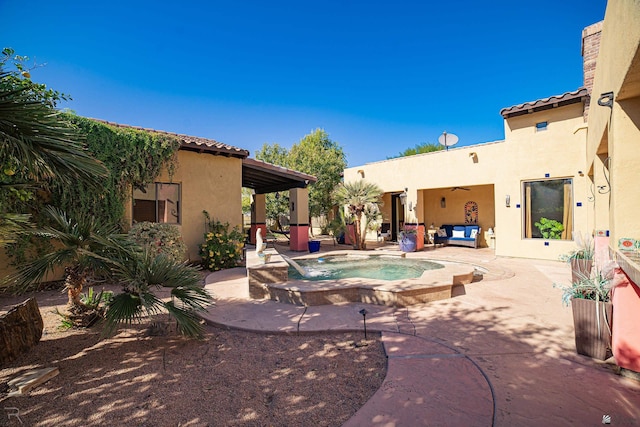 view of patio / terrace with an in ground hot tub