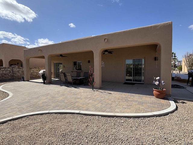 back of house featuring ceiling fan, a patio, and stucco siding