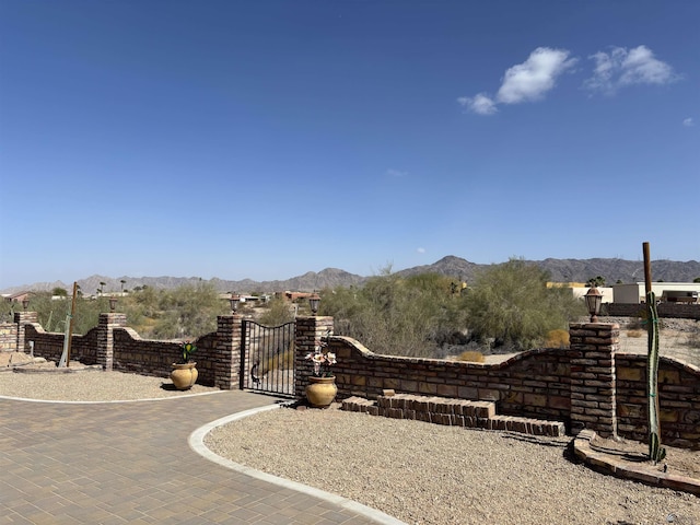 exterior space featuring a gate and a mountain view