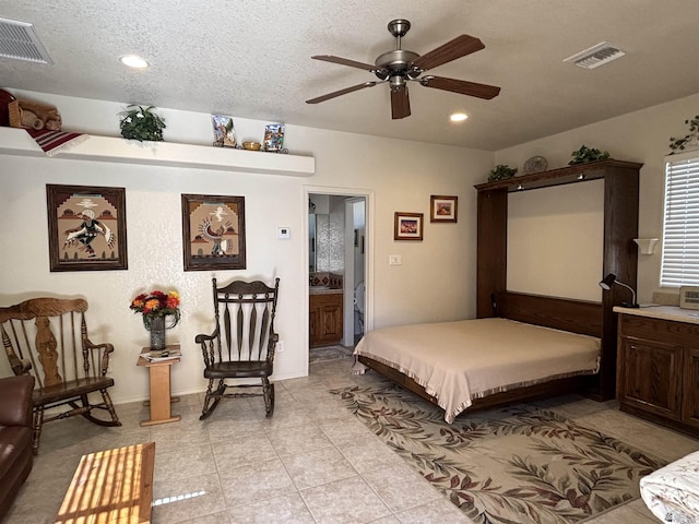 bedroom featuring light tile patterned floors, visible vents, a textured ceiling, and recessed lighting