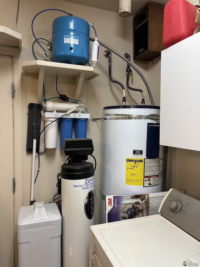 interior space featuring water heater, laundry area, and separate washer and dryer