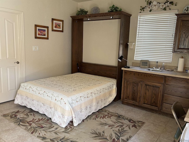 bedroom with a sink and light tile patterned floors