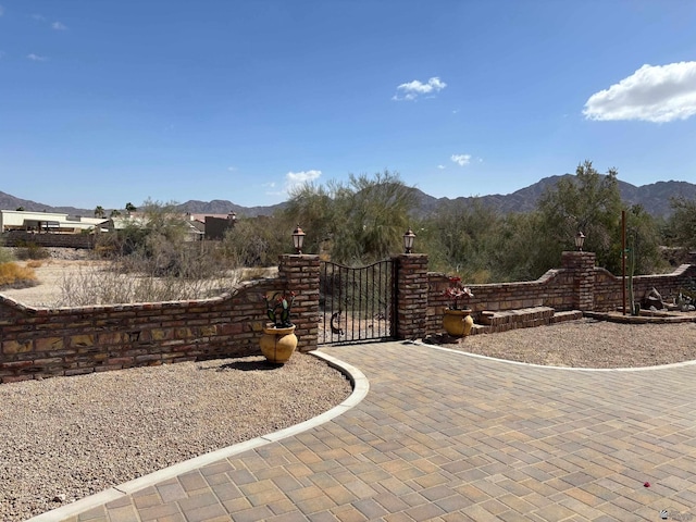 view of gate featuring a mountain view