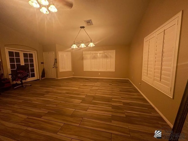 unfurnished dining area featuring ceiling fan and dark wood-type flooring