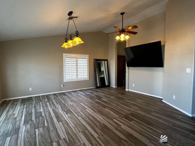 interior space featuring ceiling fan, dark wood-type flooring, and vaulted ceiling