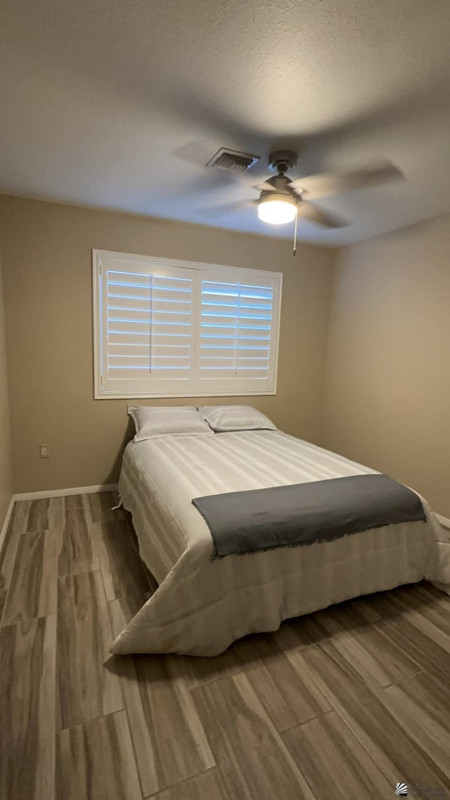 bedroom featuring hardwood / wood-style floors and ceiling fan