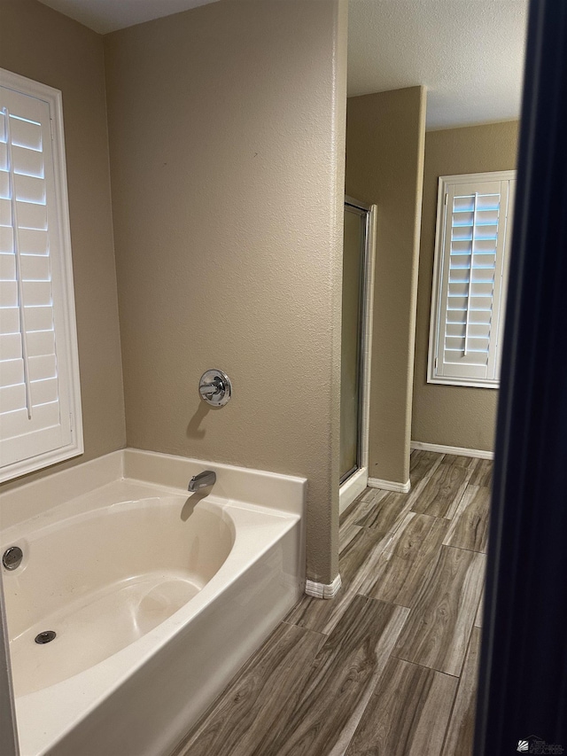 bathroom featuring independent shower and bath