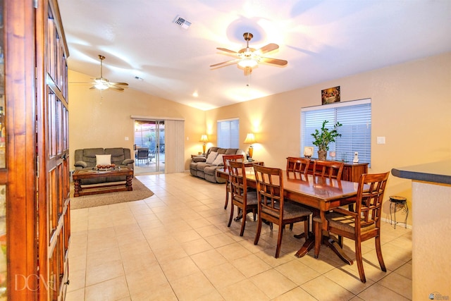 dining room featuring ceiling fan, light tile patterned floors, and vaulted ceiling