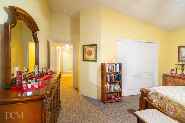 bedroom featuring a closet, carpet, and vaulted ceiling