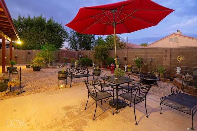 view of patio terrace at dusk