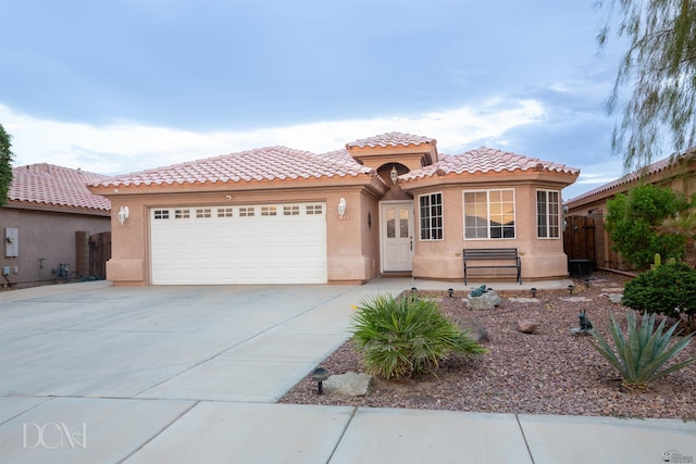 mediterranean / spanish house with a garage