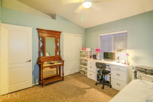 carpeted office space with ceiling fan and lofted ceiling