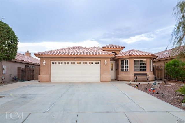 mediterranean / spanish home with a garage