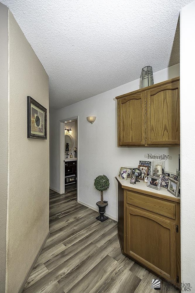 kitchen featuring dark hardwood / wood-style floors and a textured ceiling